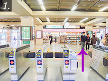 Exit through the central ticket gate.